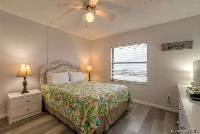a bedroom with a bed and a lamp on dresser