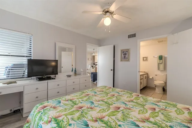 a bedroom with a bed and a flat screen tv in it