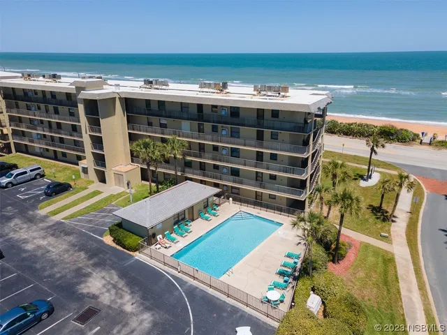 an aerial view of a house with a ocean view