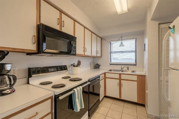 a kitchen with a sink stove top oven and microwave