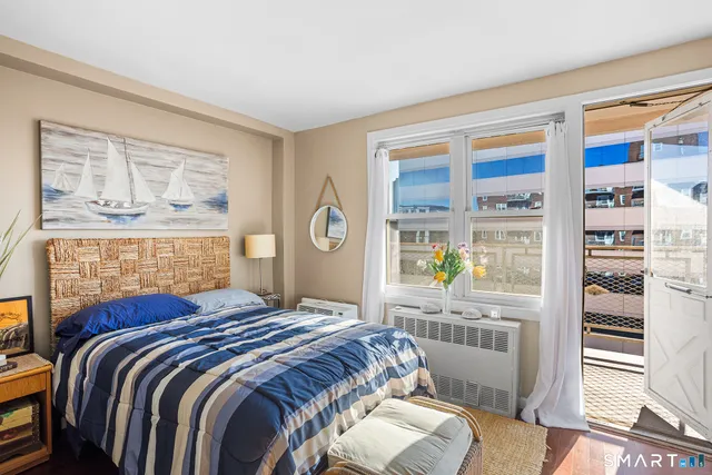 a bed sitting in a bedroom next to a window
