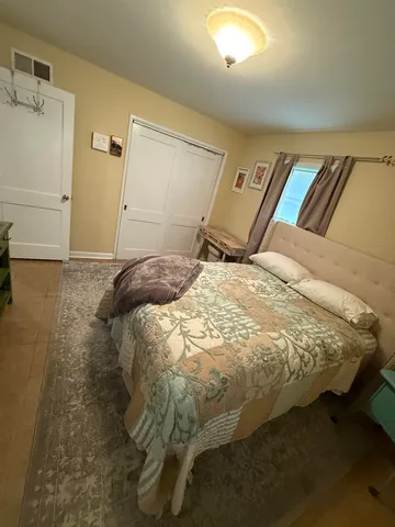 a bed sitting in a bedroom next to a bathroom