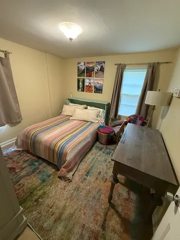 a bedroom with a bed and large mirror