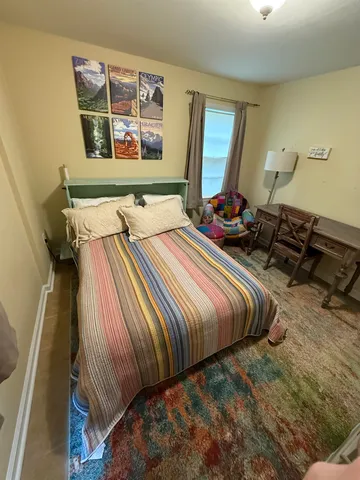 a bedroom with bed and window