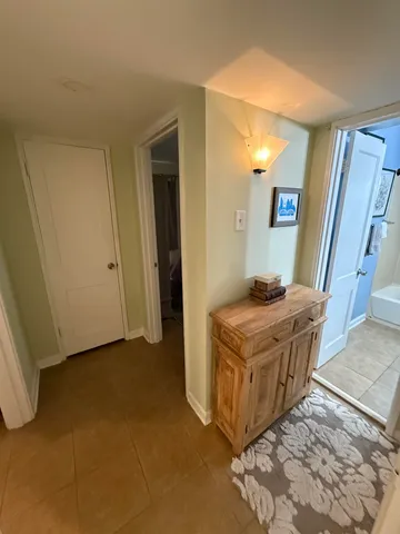 a living room with a stove and a refrigerator