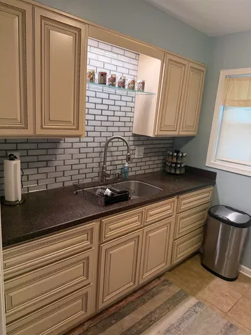 a kitchen with a sink and cabinets