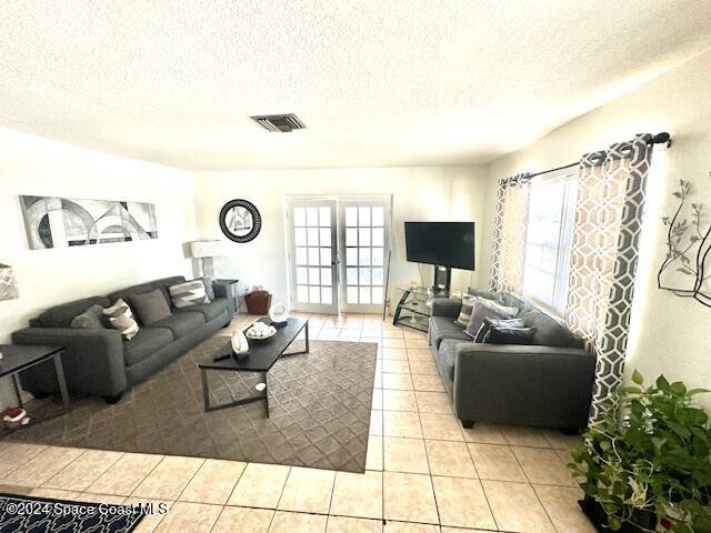 941 Croton Road Melbourne, FL 32935 - Photo 15 of 26 a living room with furniture and a flat screen tv