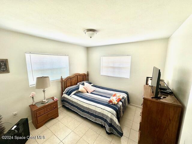 941 Croton Road Melbourne, FL 32935 - Photo 18 of 26 a bedroom with a bed and a dresser
