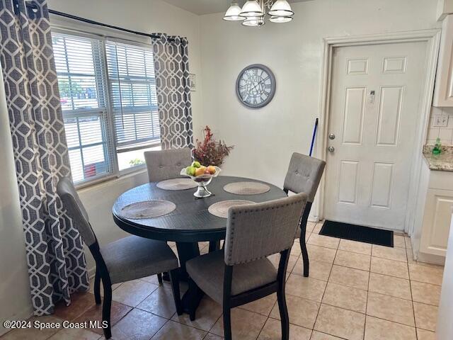 941 Croton Road Melbourne, FL 32935 - Photo 23 of 26 a view of a dining room with furniture and chandelier