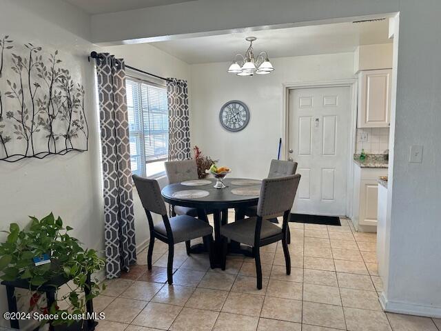 941 Croton Road Melbourne, FL 32935 - Photo 24 of 26 a view of a dining room with furniture and chandelier