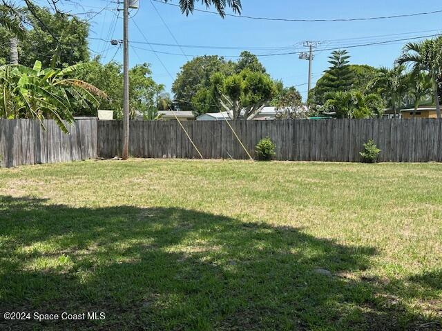 941 Croton Road Melbourne, FL 32935 - Photo 5 of 26 a view of outdoor space with green field and trees in the background