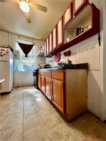 a view of a kitchen with stainless steel appliances and cabinets