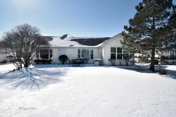 a view of a house with a snow in the yard