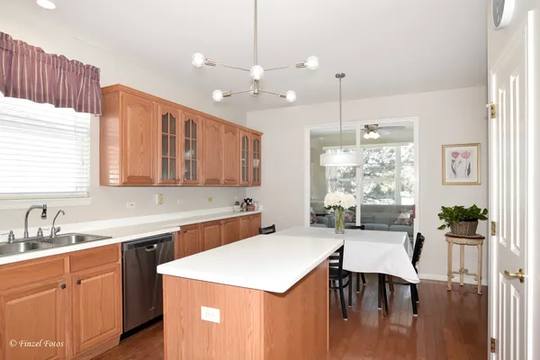 a kitchen with a table chairs stove and cabinets