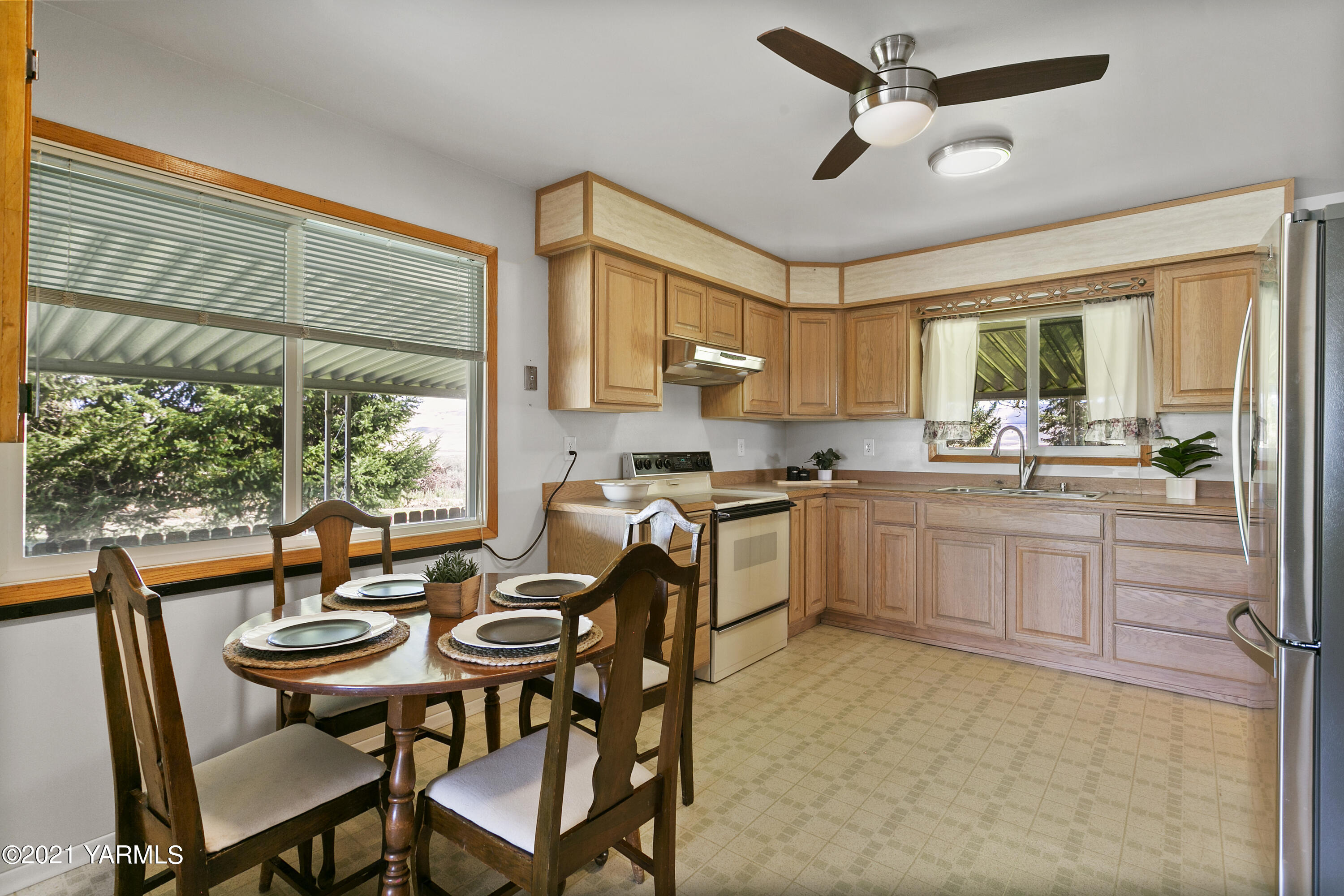 90601 West McCreadie Road Prosser, WA 99350 - Photo 7 of 8 a kitchen with a table chairs stove and cabinets