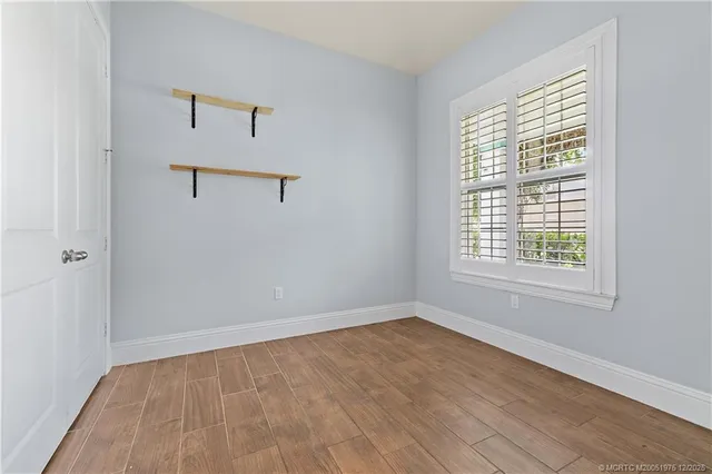 wooden floor in an empty room with a window