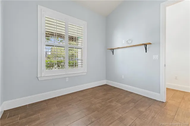 a bathroom with a granite countertop sink mirror and a bathtub