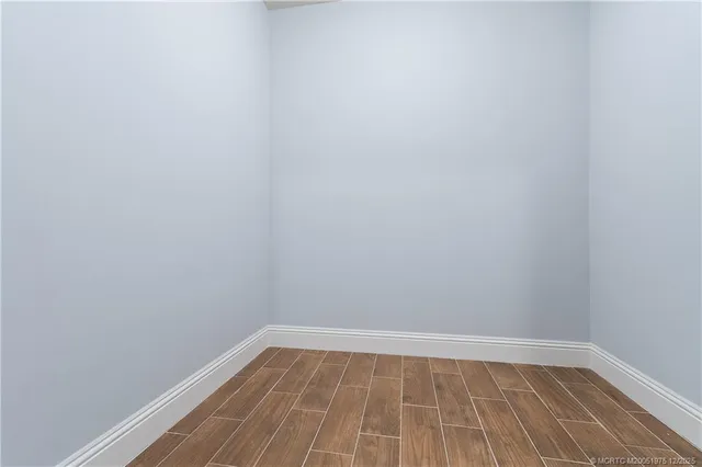 an aerial view of a city with lots of residential buildings and ocean view in back