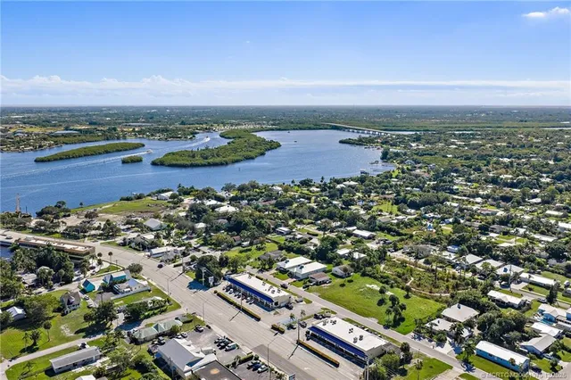 an aerial view of multiple houses with yard