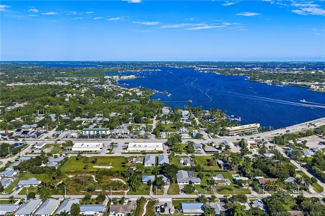 an aerial view of multiple houses with a yard