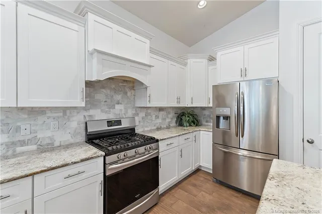 a large kitchen with kitchen island a dining table and chairs