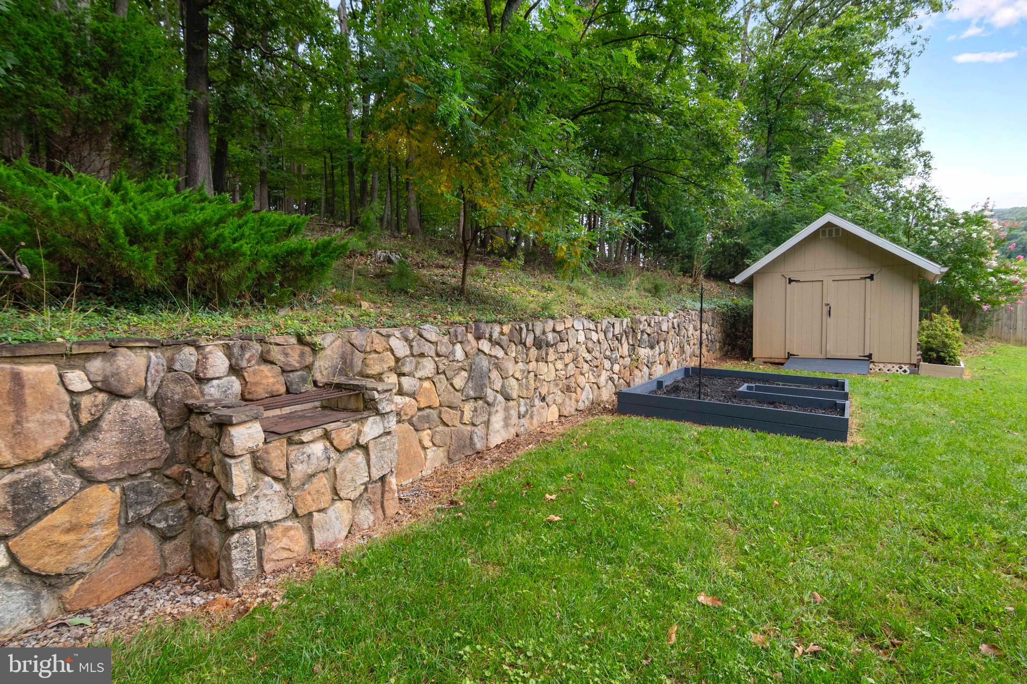 116 Richmond Road Front Royal, VA 22630 - Photo 49 of 60 Backyard with stone retaining wall and grill.