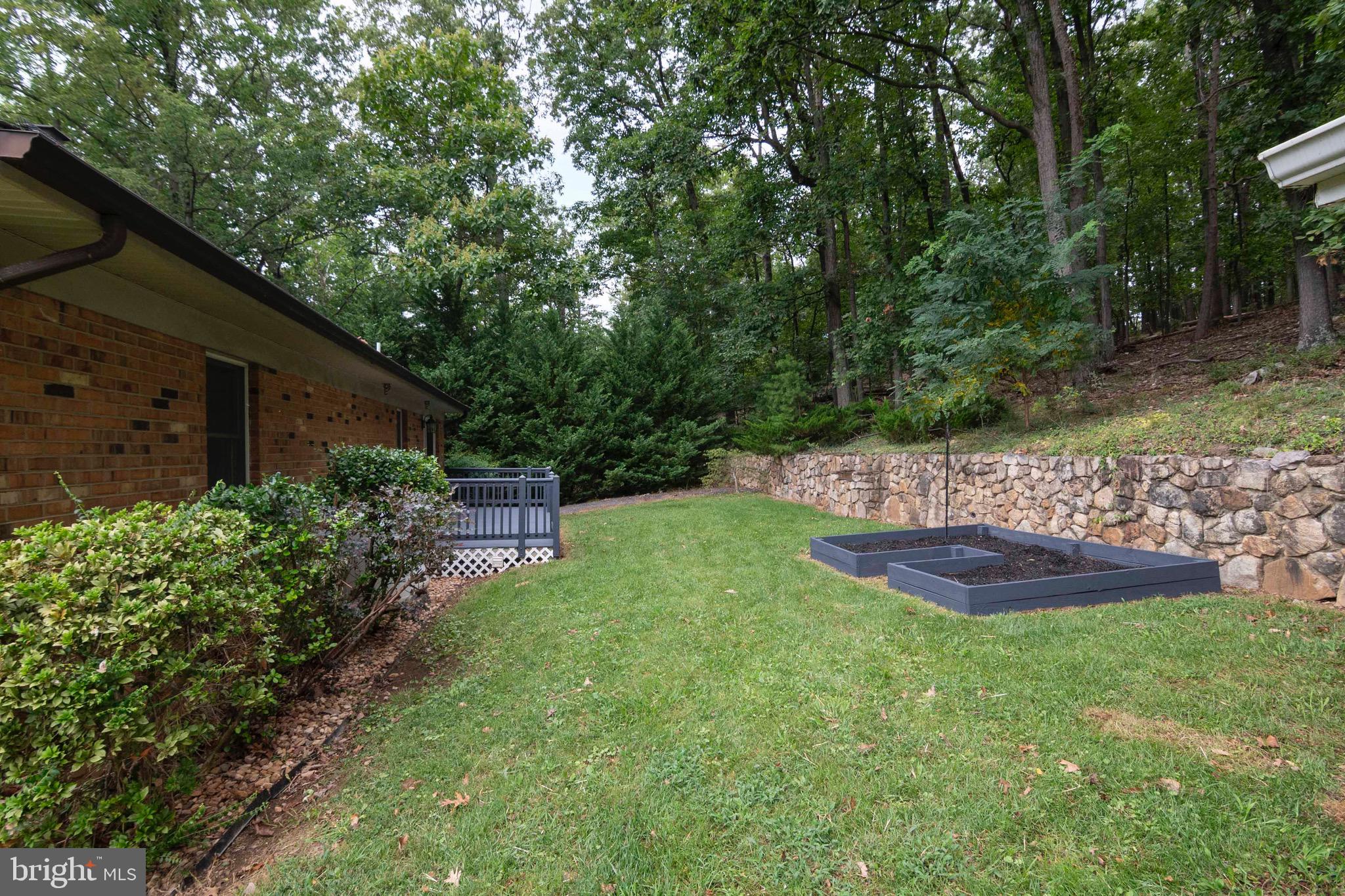 116 Richmond Road Front Royal, VA 22630 - Photo 53 of 60 Backyard with stone retaining wall and grill.
