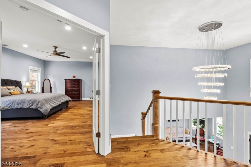 1993 Amwell Road Somerset, NJ 08873 - Photo 16 of 45 a spacious bedroom with a large bed and a chandelier