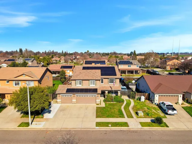 an aerial view of residential houses with outdoor space