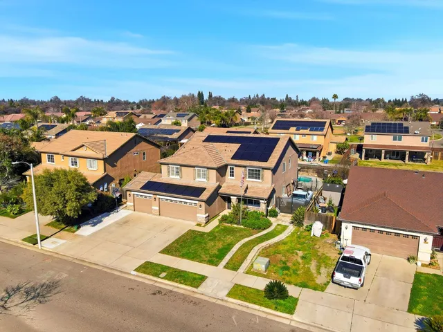an aerial view of residential houses with outdoor space