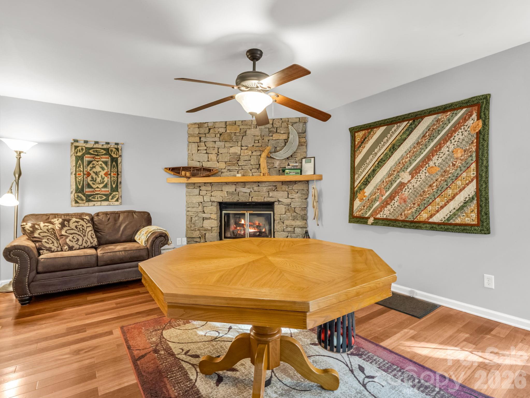 108 Nuthatch Trace Brevard, NC 28712 - Photo 12 of 46 a living room with furniture a flat screen tv and a fireplace