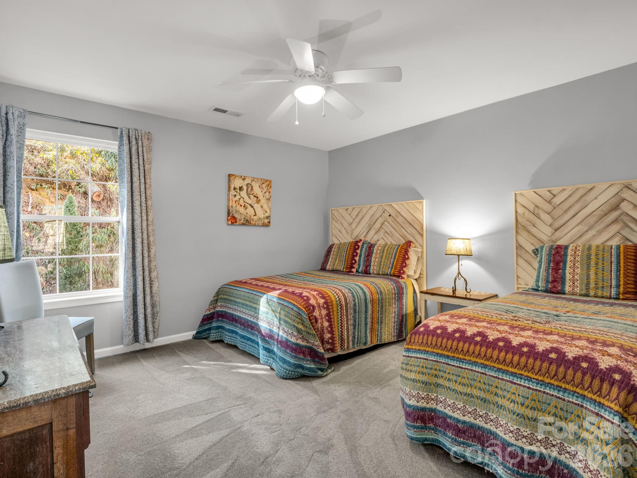 108 Nuthatch Trace Brevard, NC 28712 - Photo 18 of 46 a bedroom with two beds and a chandelier