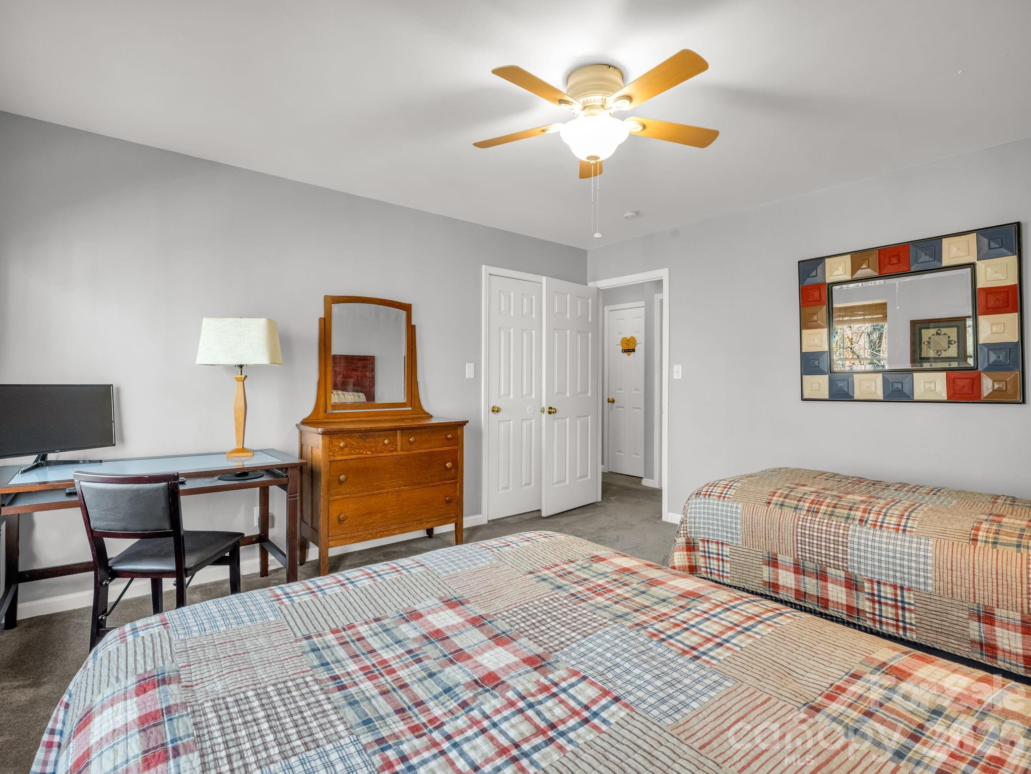108 Nuthatch Trace Brevard, NC 28712 - Photo 26 of 46 a bedroom with a bed and a chandelier