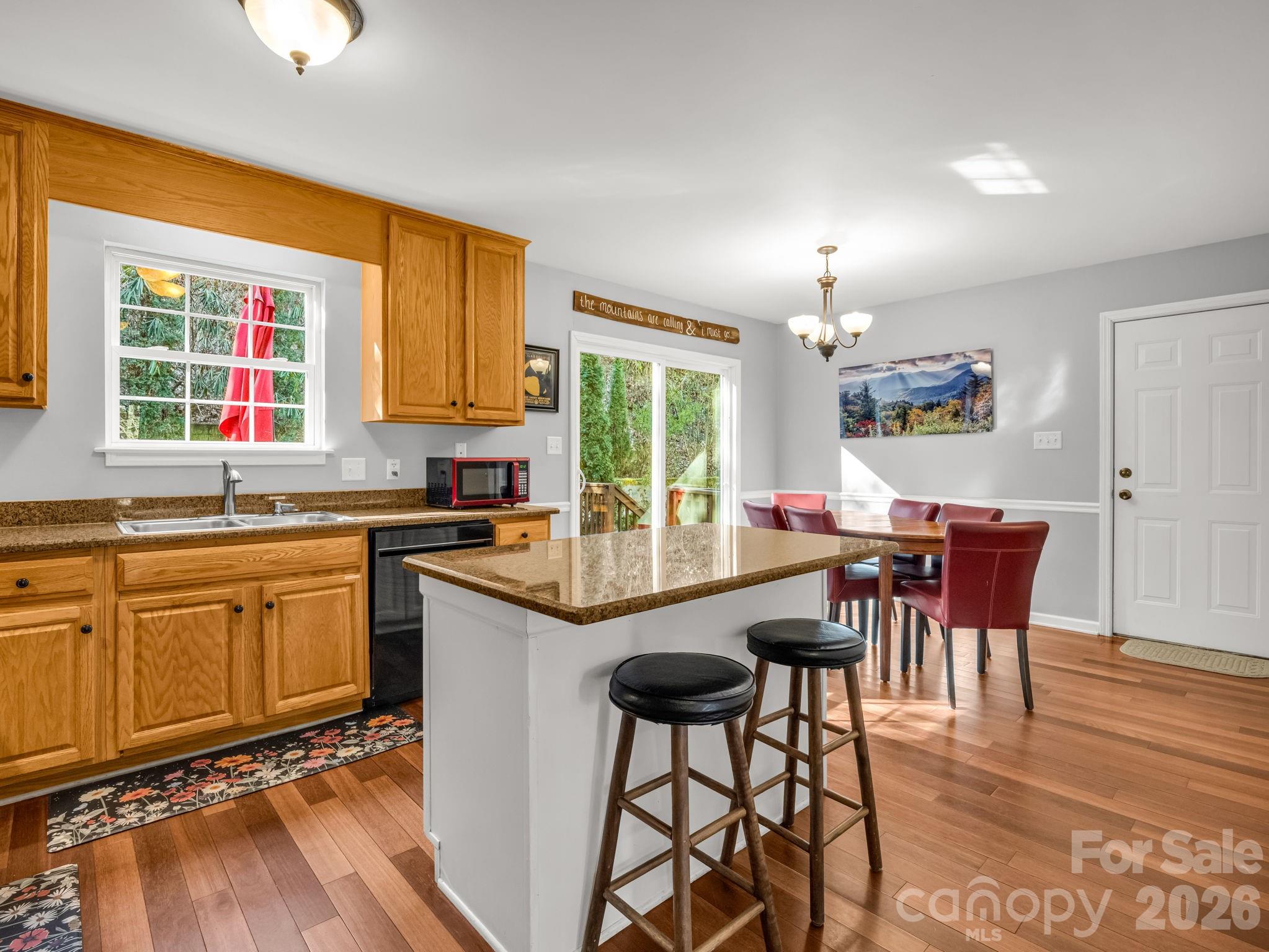 108 Nuthatch Trace Brevard, NC 28712 - Photo 3 of 46 a kitchen with granite countertop wooden floors and white appliances