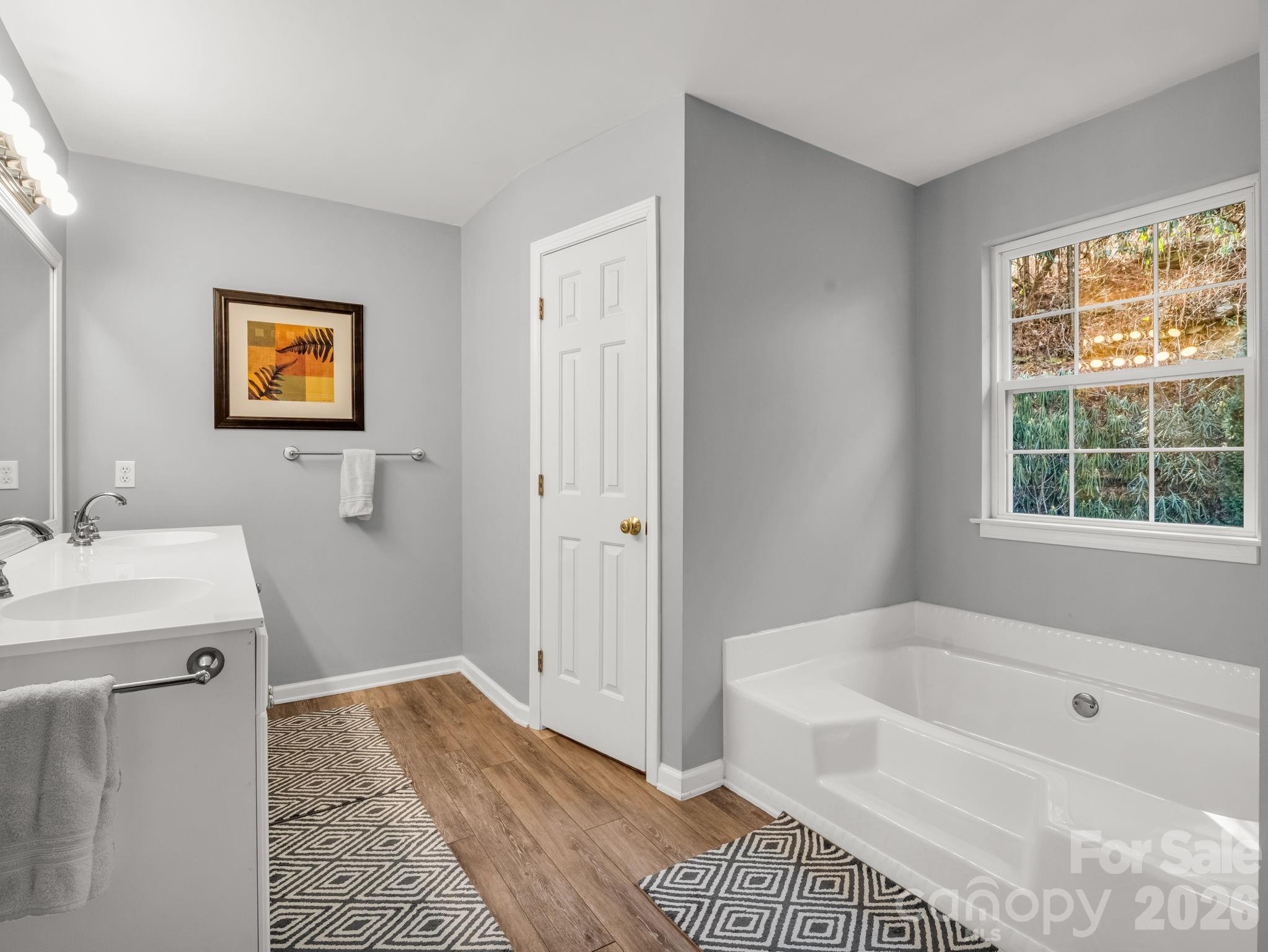 108 Nuthatch Trace Brevard, NC 28712 - Photo 31 of 46 a bathroom with a tub sink and a window