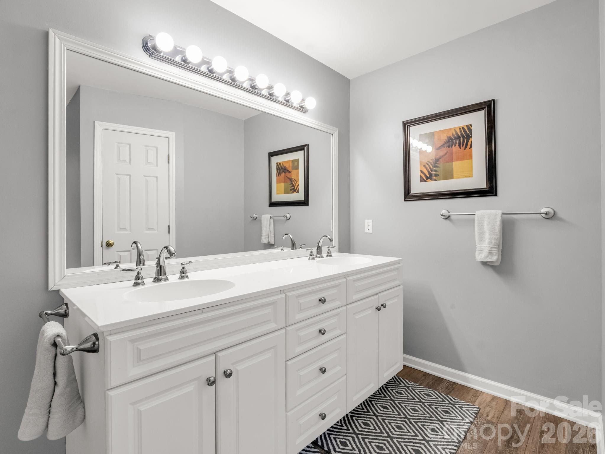 108 Nuthatch Trace Brevard, NC 28712 - Photo 33 of 46 a spacious bathroom with a double vanity sink a mirror and a window