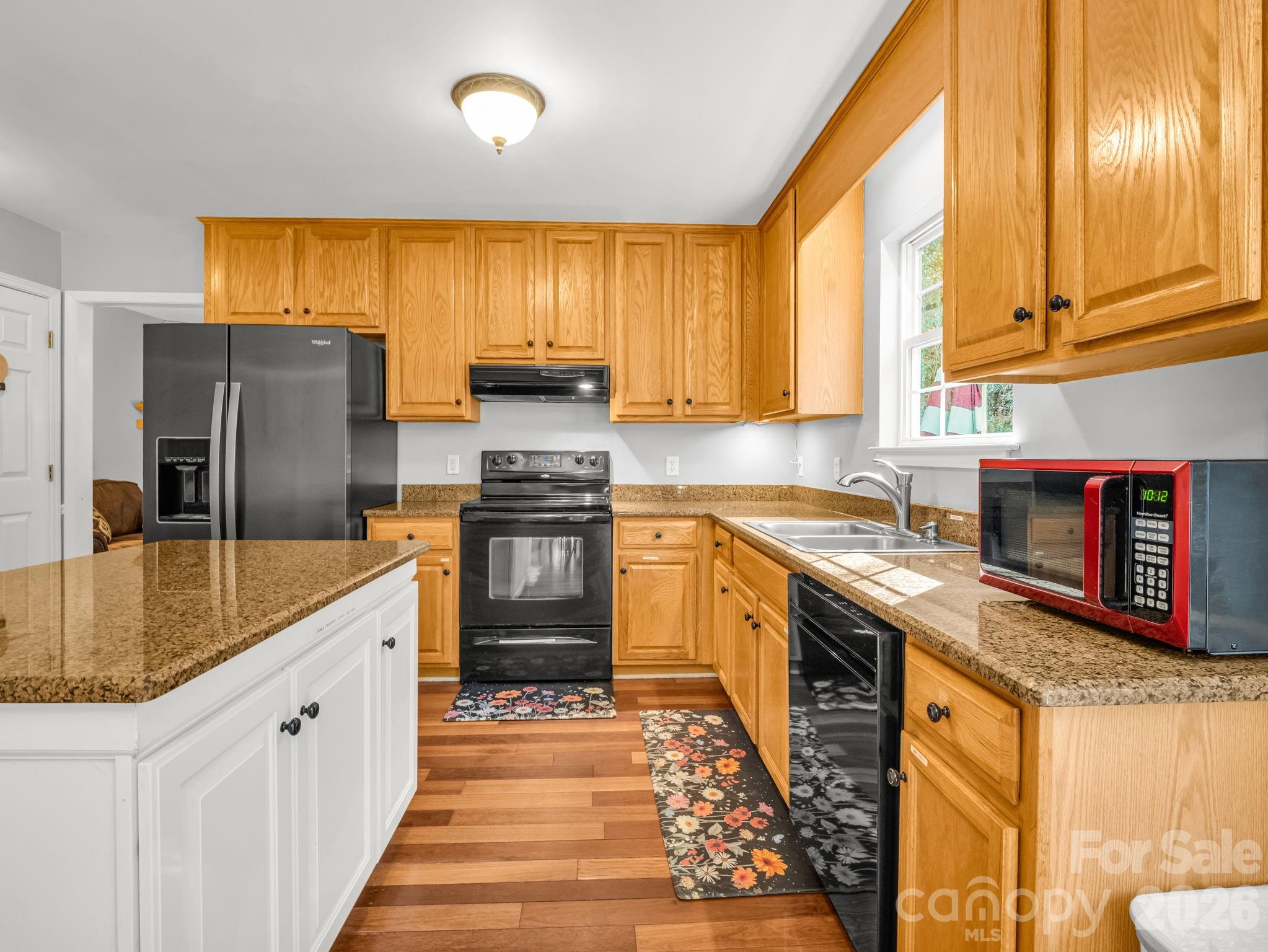 108 Nuthatch Trace Brevard, NC 28712 - Photo 4 of 46 a large kitchen with stainless steel appliances granite countertop a sink and a refrigerator