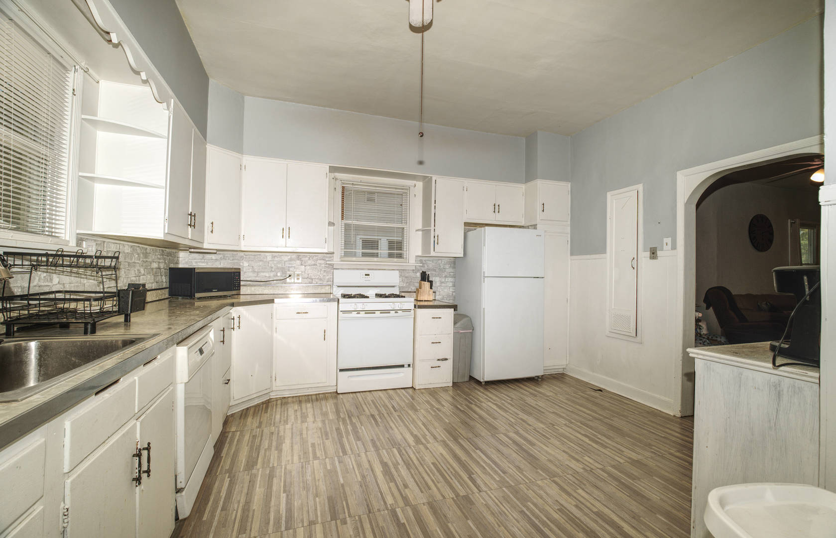 2108 Camanche Avenue Clinton, IA 52732 - Photo 5 of 22 a kitchen with white cabinets and white appliances