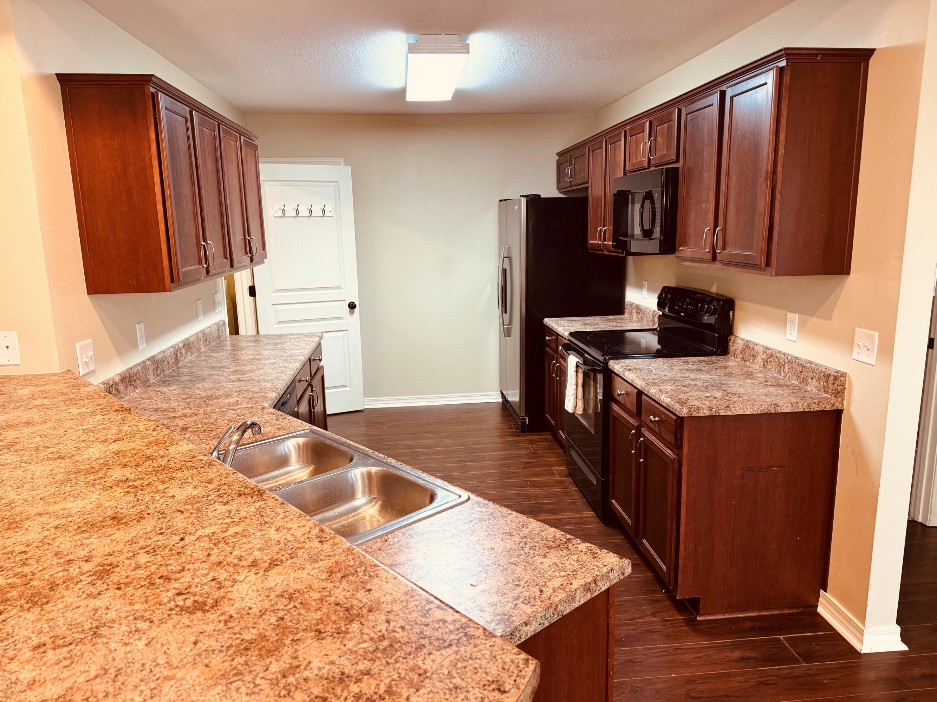 594 Hunters Ridge Road DeFuniak Springs, FL 32433 - Photo 5 of 17 a kitchen with granite countertop a sink stove and cabinets