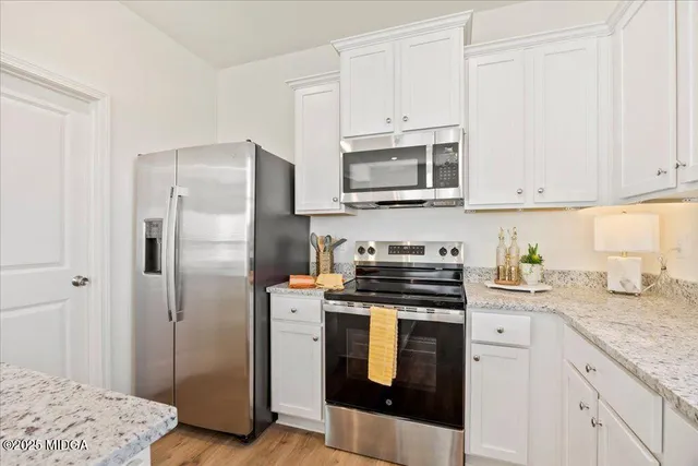 a view of living room with furniture and wooden floor