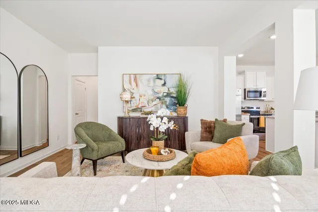 a living room with furniture and wooden floor