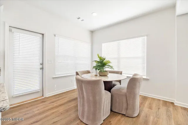 a view of a dining room with furniture and wooden floor