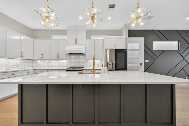 a kitchen with cabinets table and chairs