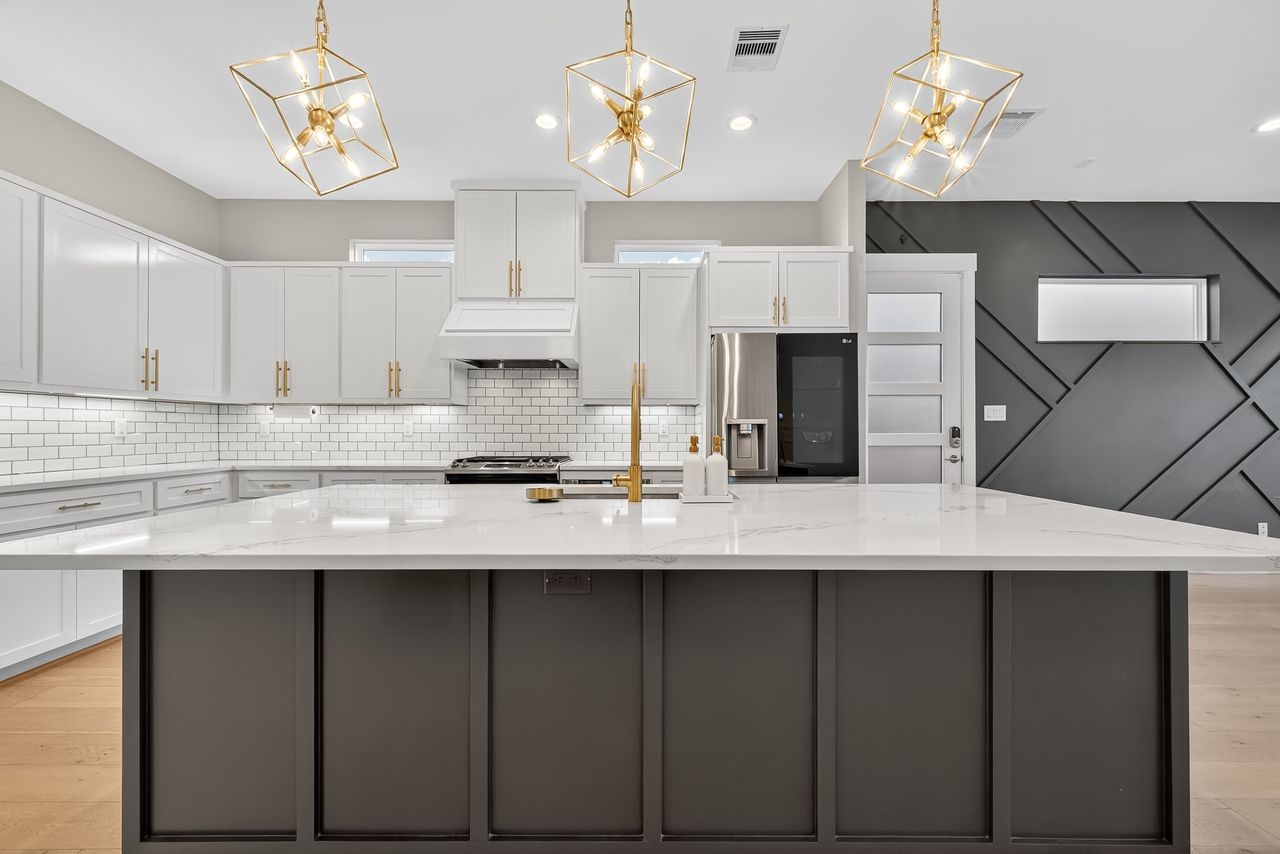 4508 Hardy Street, Unit B Houston, TX 77009 - Photo 12 of 40 a kitchen with cabinets table and chairs