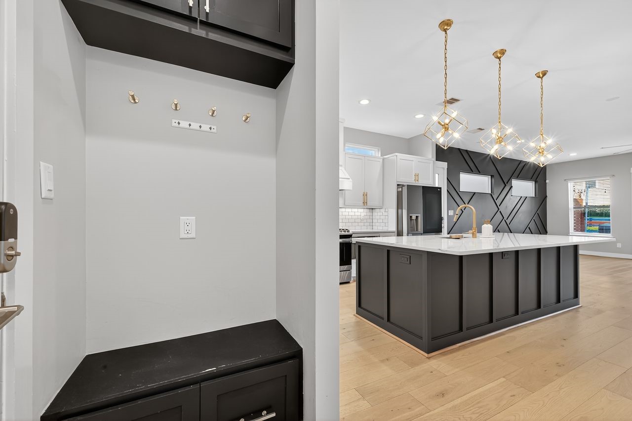 4508 Hardy Street, Unit B Houston, TX 77009 - Photo 13 of 40 a kitchen with stainless steel appliances a refrigerator and a wooden floor