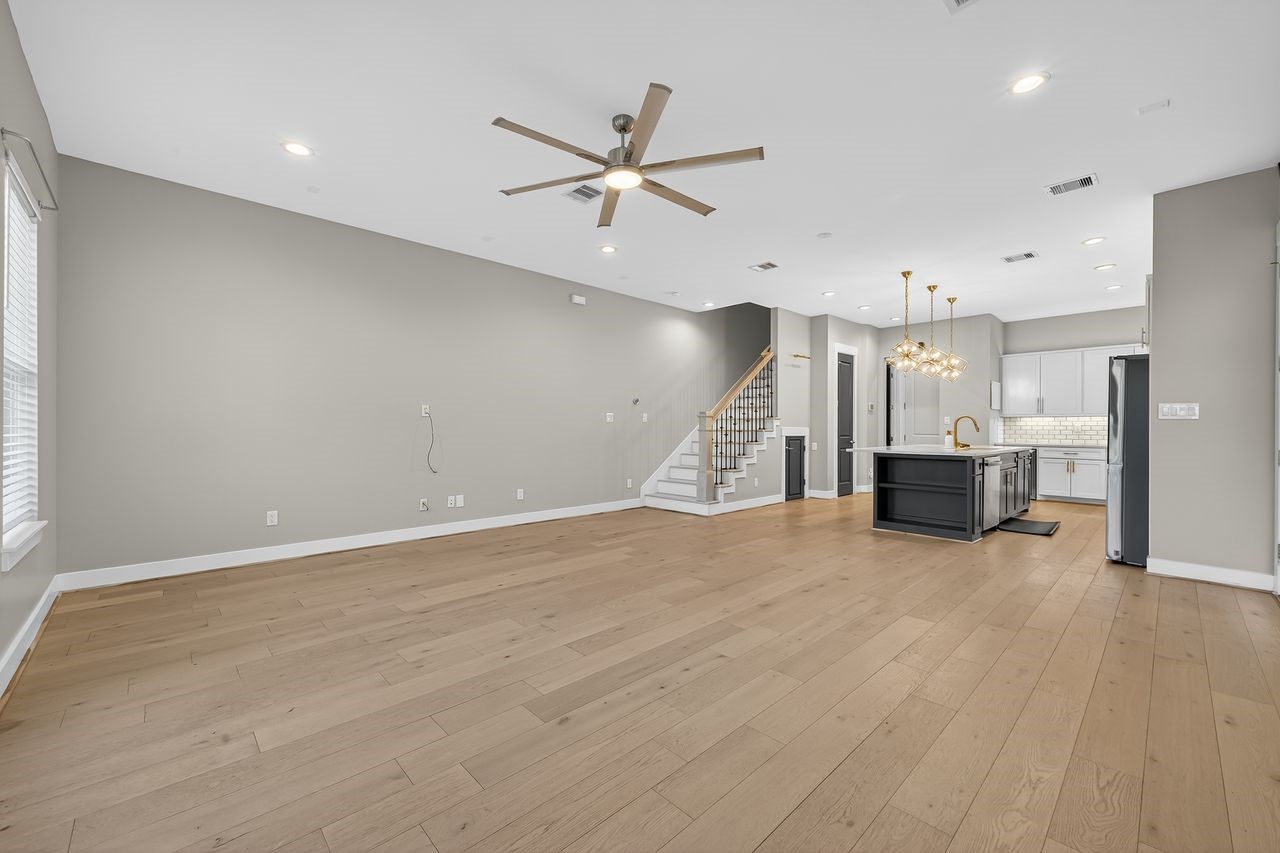4508 Hardy Street, Unit B Houston, TX 77009 - Photo 2 of 40 an empty room with wooden floor and windows