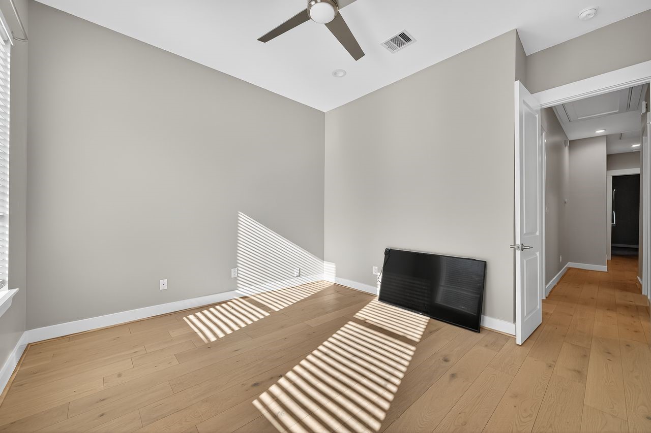 4508 Hardy Street, Unit B Houston, TX 77009 - Photo 24 of 40 a bedroom with a bed and a walk in closet