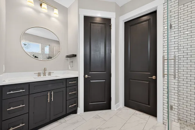 a bathroom with a double vanity sink and a mirror