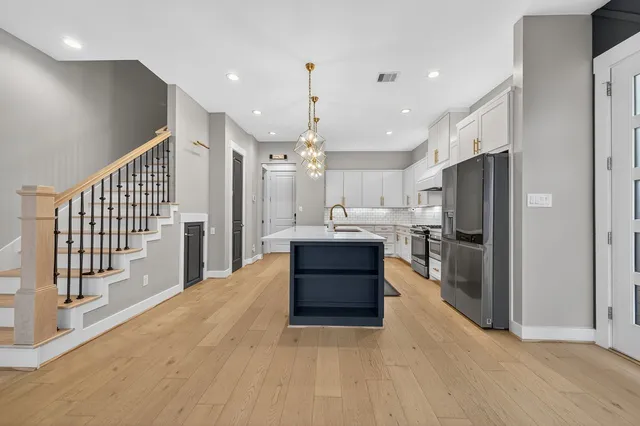 a large kitchen with a large window and stainless steel appliances
