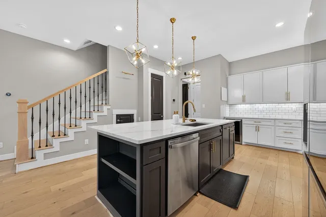 a kitchen with a stove kitchen island and stainless steel appliances